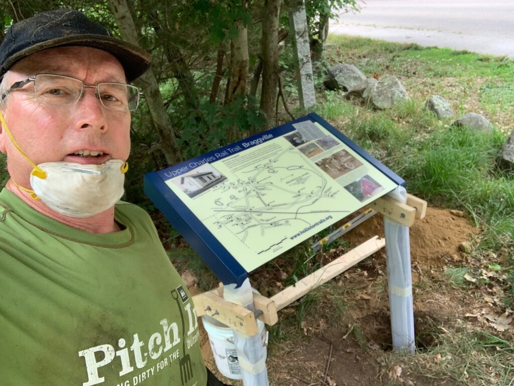 Robert Weidknecht and one of his interpretive signs along the Upper Charles Rail Trail in Holliston, MA