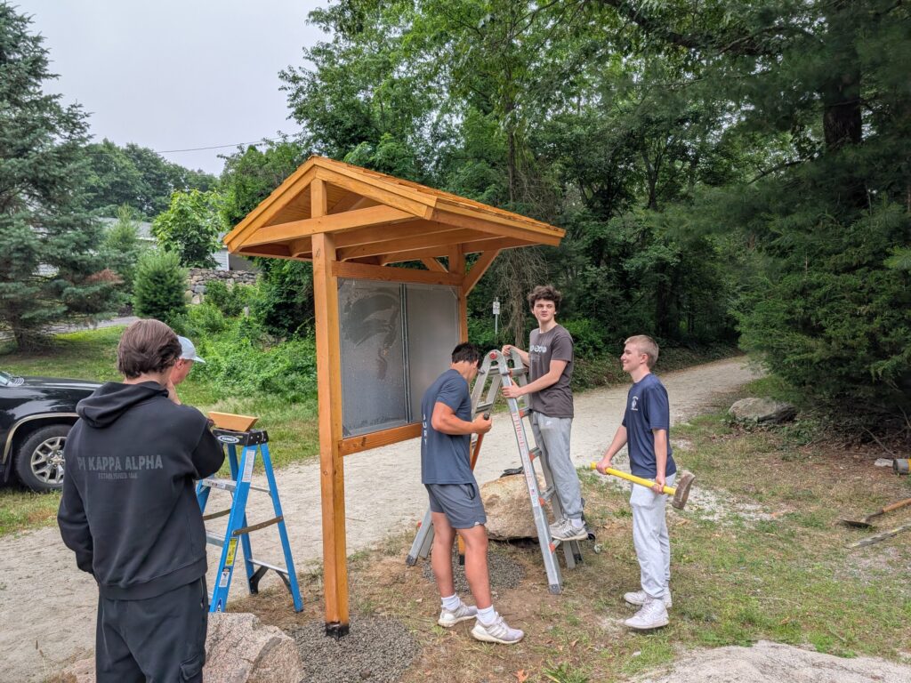 Scouts installing the kiosk on Farm Street